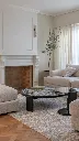 Elegant living room with fireplace and tree.webp