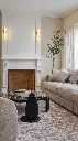 Warmly lit fireplace with elegant sconces.webp